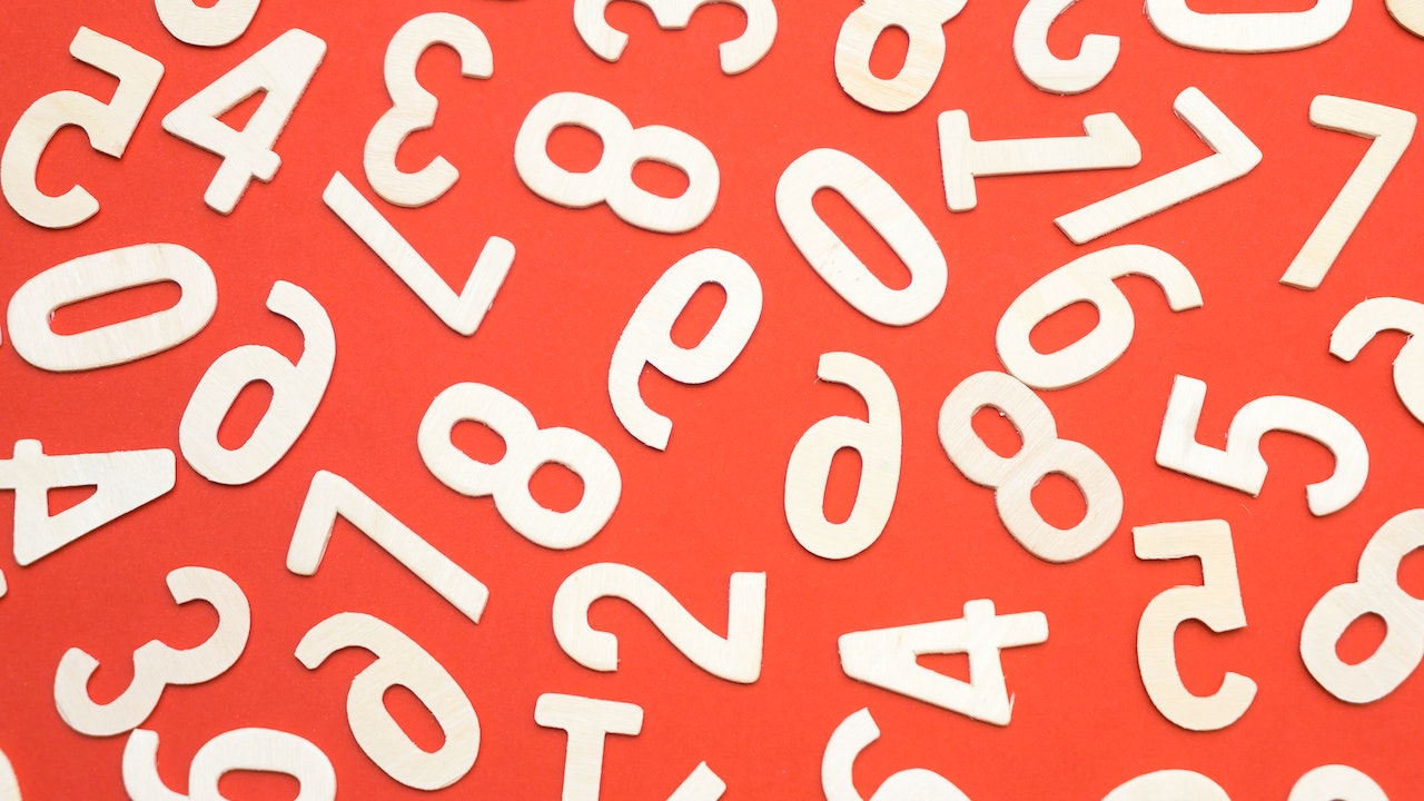 many different white numbers on the red background