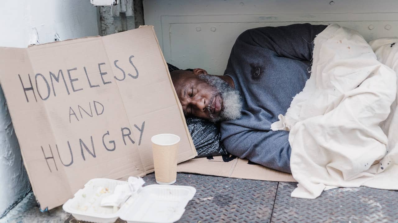 homeless man sleeping in the street