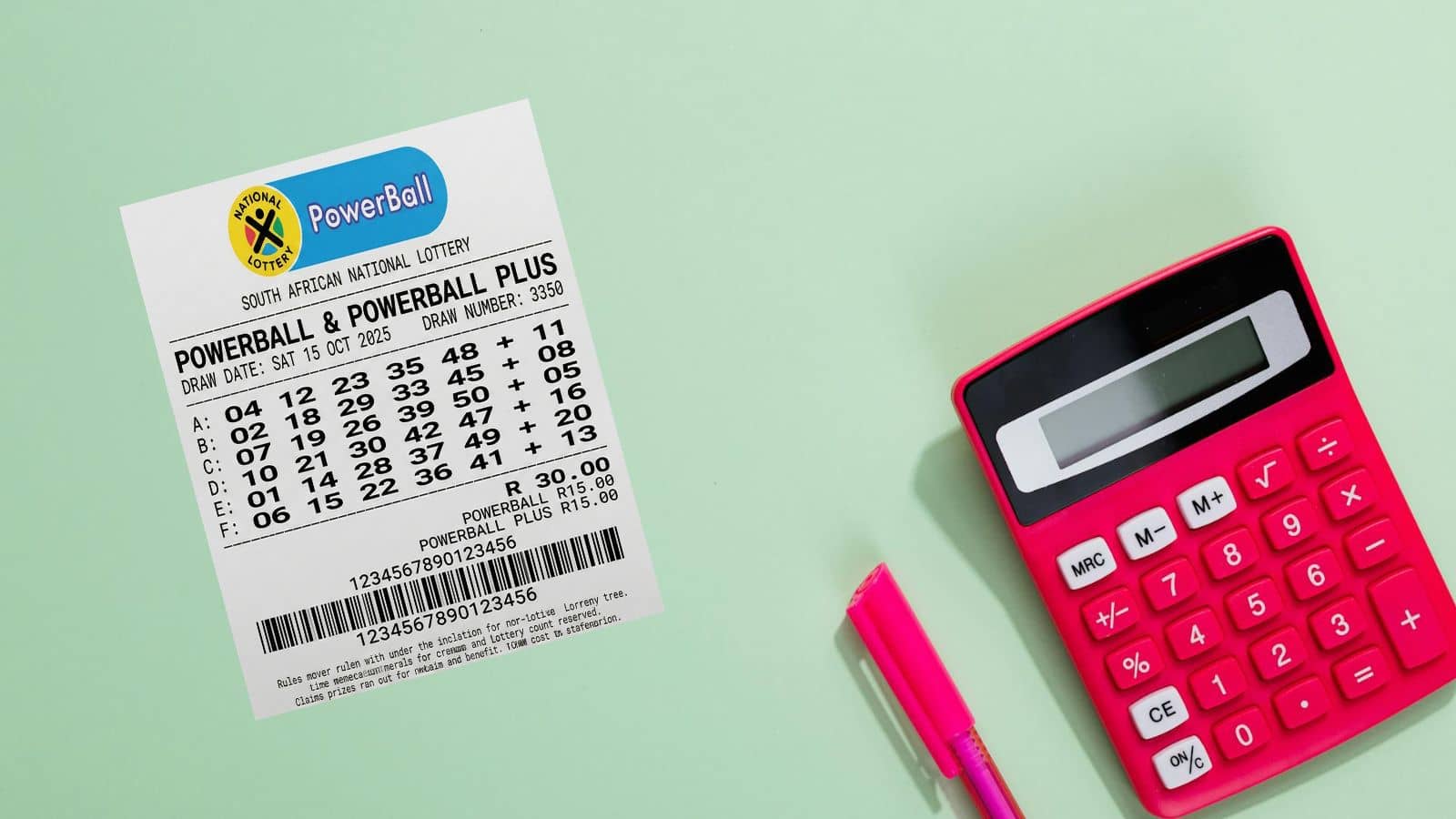south africa powerball ticket and pen and calculator on green surface
