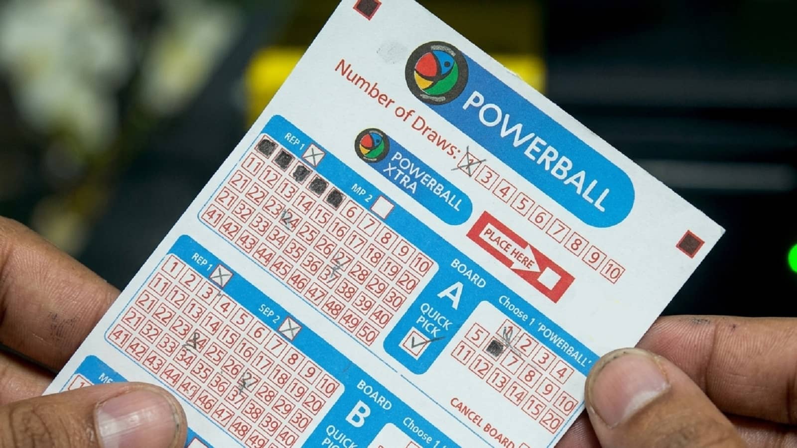 powerball and powerball Xtra ticket in hands
