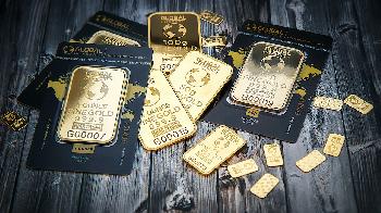 certified gold ounces laying on black table