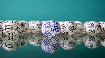 many white lottery balls with numbers printed