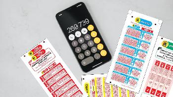 south african lottery tickets and calculator on the marble surface