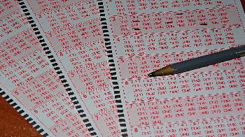 lottery tickets on the table around the pencil