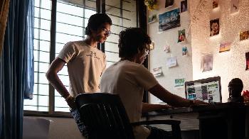 two men searching for something with their notebook