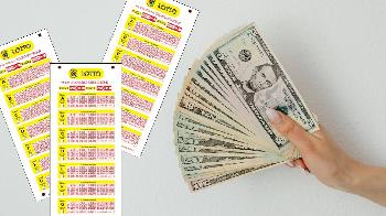 lotto tickets and money held by hand