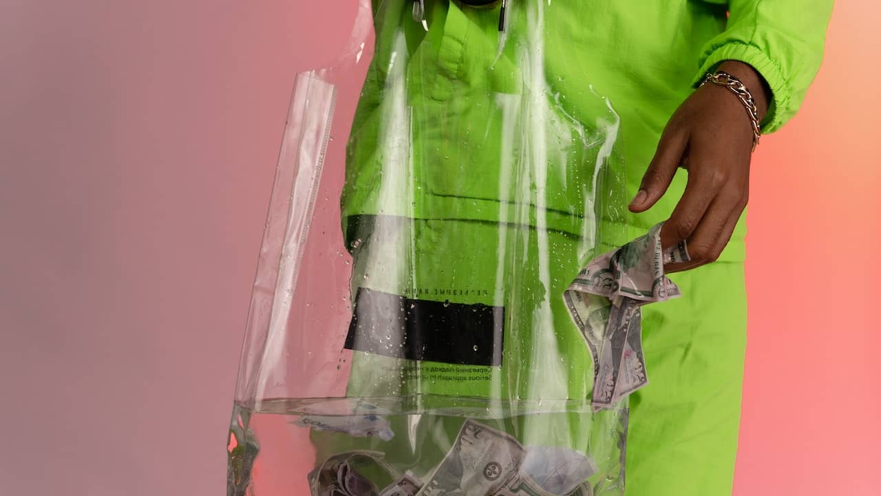 man literally washing the banknotes in water